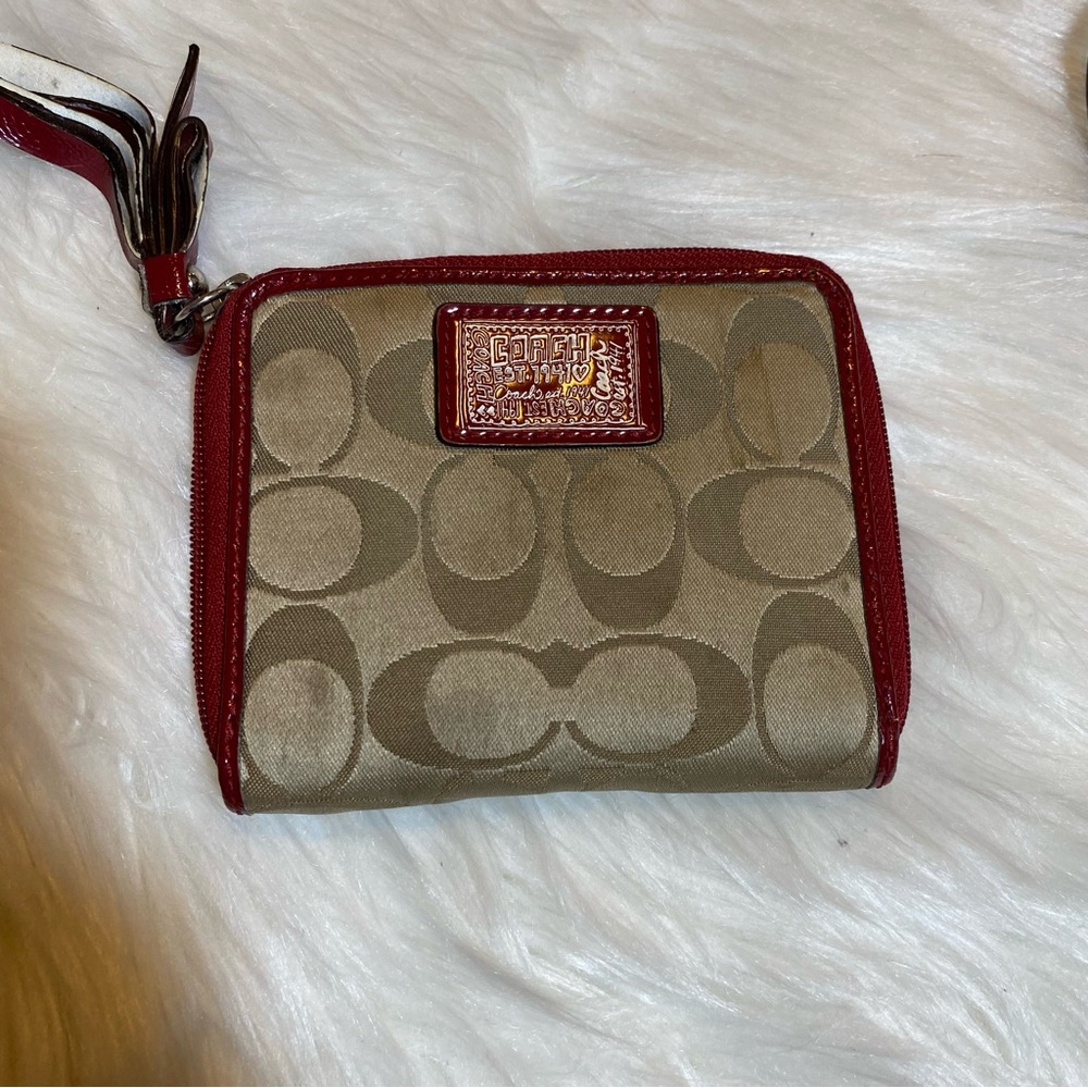 Red and tan coach wallet with wrist strap